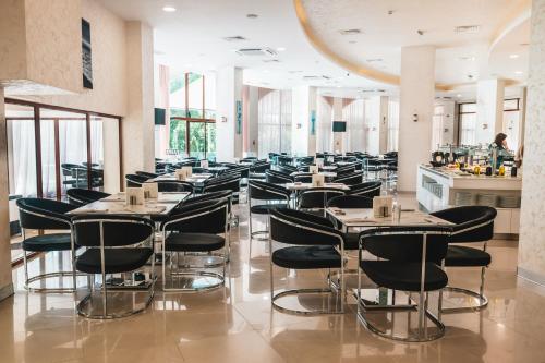 a row of tables and chairs in a restaurant at Hotel Continental in Golden Sands