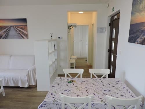 a room with a table and chairs and a bed at Apartments Villa Elma in Mošćenička Draga