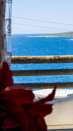 a group of people looking out at the ocean at The Bay Apartments in Sarandë