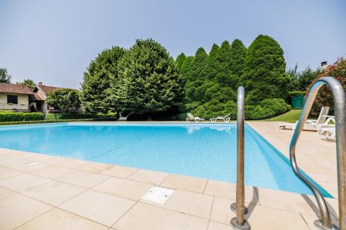 a swimming pool with metal railings in a yard at Appartamento Dolce Casa 2 in  Monvalle 