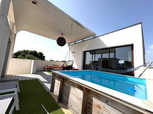 a swimming pool on the roof of a house at GuestHouse Le Patio34 in Lavérune