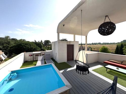 a swimming pool on the deck of a house at GuestHouse Le Patio34 in Lavérune