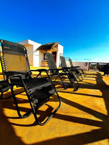 a row of chairs sitting on top of a roof at Hotel Villas Ponto Holbox in Holbox Island