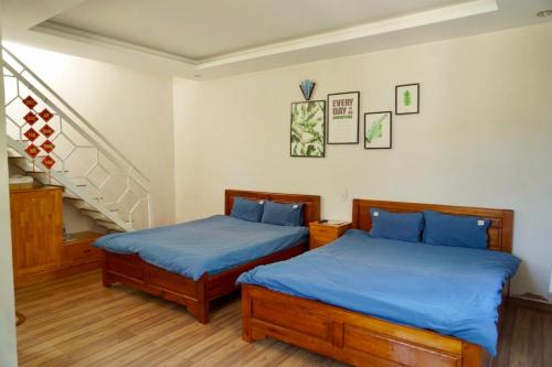 Postel nebo postele na pokoji v ubytování Moonlight Homestay