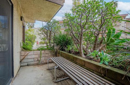 a bench sitting outside of a building with trees at Condo Near LAX & Sofi in Los Angeles
