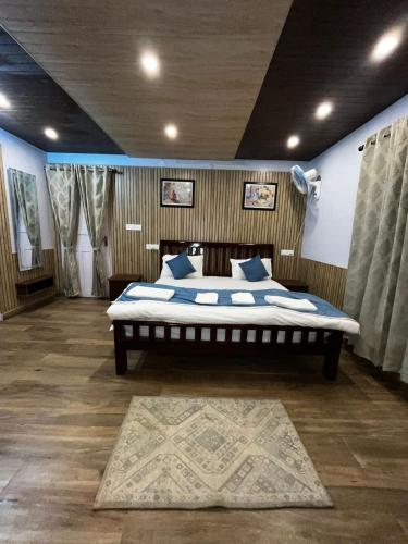 a bedroom with a large bed in a room at Bayberry Suites in Mukteswar