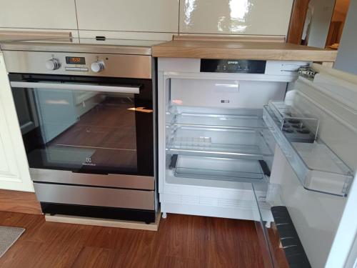 an empty refrigerator with its door open in a kitchen at Green view apartment in Sežana