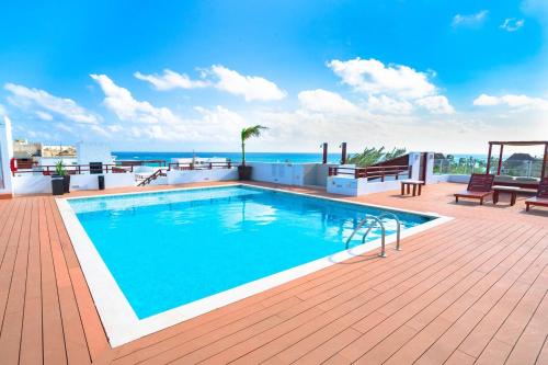 a swimming pool on the roof of a building at Penthouse Turquesa - Beachside - At Casa del Mar Condos in Playa del Carmen