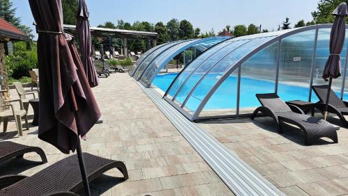 a group of umbrellas sitting next to a swimming pool at SEDRA Holiday Resort-Adults Only-Bed & Breakfast in Grabovac