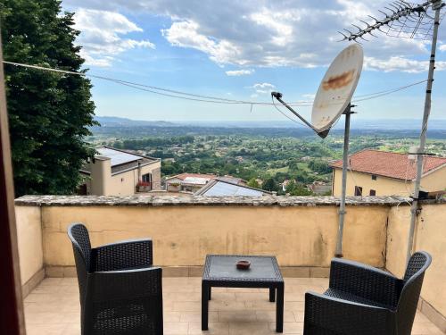 a patio with chairs and a table and an umbrella at Villa Nia affittacamere in Palestrina