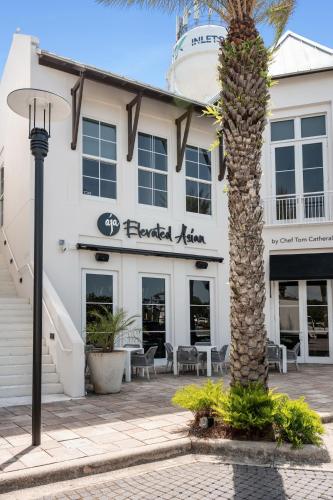 a palm tree in front of a hotel at 3Zs Beach House 30A Sleeps 10! in Inlet Beach