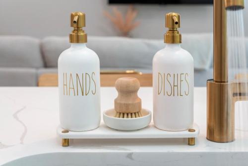 two bottles with handles and a wooden brush on a table at 3Zs Beach House 30A Sleeps 10! in Inlet Beach
