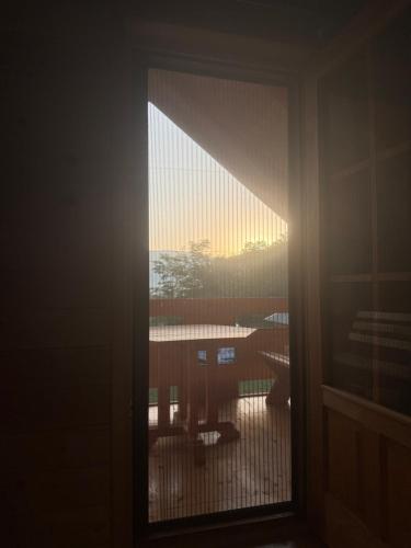 a view of a window with a view of a balcony at Konaci Očeva Zemlja Vikendica i Bungalovi in Mojkovac
