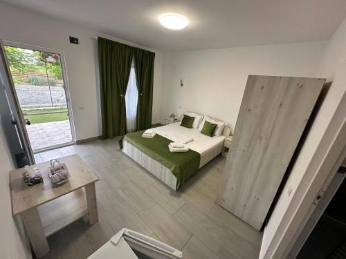 a hotel room with a bed and a large window at Houses by the sea in Vadu