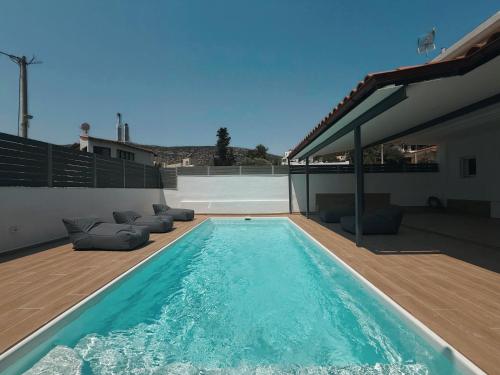 a swimming pool on the roof of a house at Seaview Complex with Pool in Porto Rafti