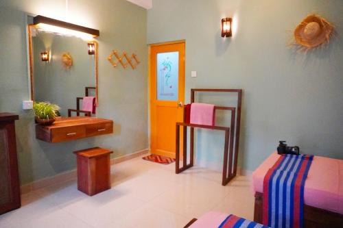 a room with a bathroom with a sink and a mirror at 7elements - Boutique Hotel & Restaurant in Weligama