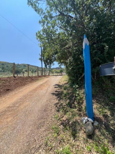 a blue sign on the side of a dirt road at Casa di campagna nel Parco del Pollino in Teana
