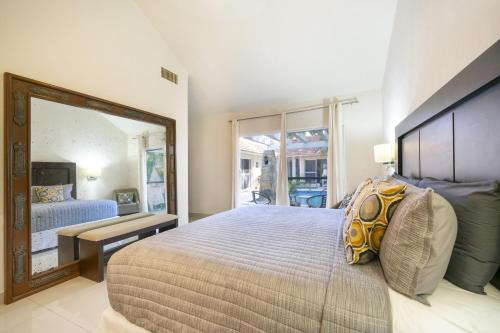 a bedroom with a large bed and a mirror at Luxury Villa 4BR with Private Pool - At Playacar ll - Villa Perla 15 in Playa del Carmen