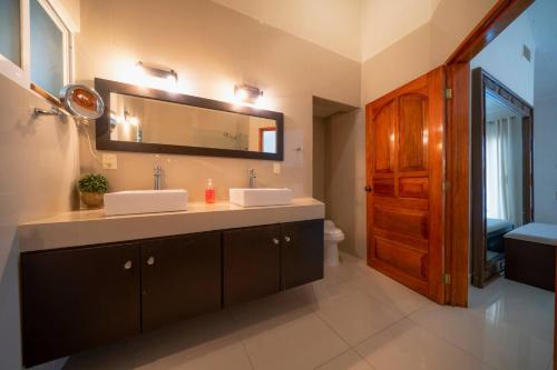a bathroom with two sinks and a mirror at Luxury Villa 4BR with Private Pool - At Playacar ll - Villa Perla 15 in Playa del Carmen