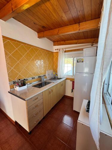 a kitchen with a sink and a refrigerator at Apartamento junto al mar El Roque in Santa Cruz de Tenerife