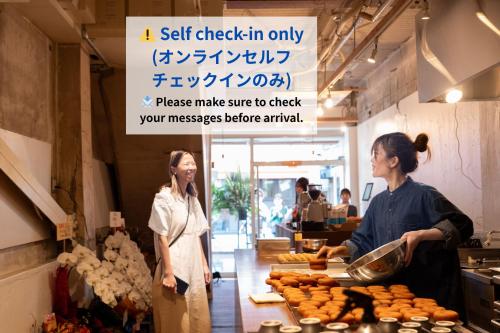 two women standing in a kitchen preparing food at hostel Ini kobe l Self Cozy Stay in Kobe