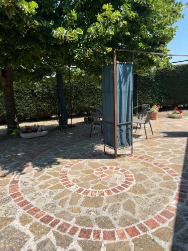 a circle on a stone patio with a tree at Casa di campagna nel Parco del Pollino in Teana