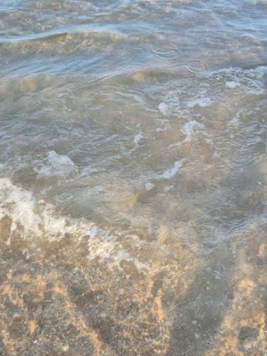 a body of water with rocks in it at Homestay The Sunset in Phan Thiet