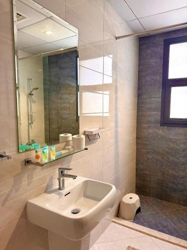 a bathroom with a sink and a mirror at Lux 4 with Assistance room with Pool and Sea View in Fujairah