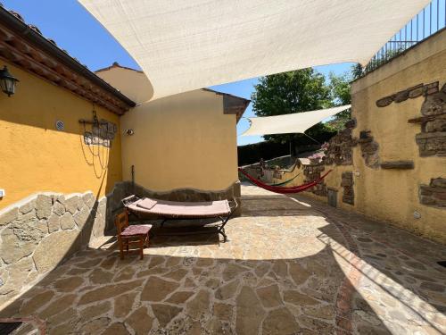 a patio with a table and a chair in a building at Casa di campagna nel Parco del Pollino in Teana