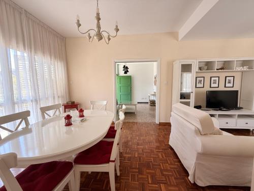 a living room with a white table and chairs at Green Door 3bdr flat City Centre in Nicosia