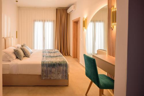 a hotel room with a bed and a desk at Casa della Liberta in Firostefani
