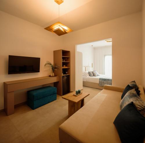 a living room with a couch and a tv at Casa della Liberta in Firostefani