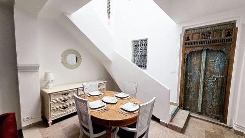 a dining room with a wooden table and chairs at Bleu Azur - Sidi Bou Saïd in Sidi Bou Saïd