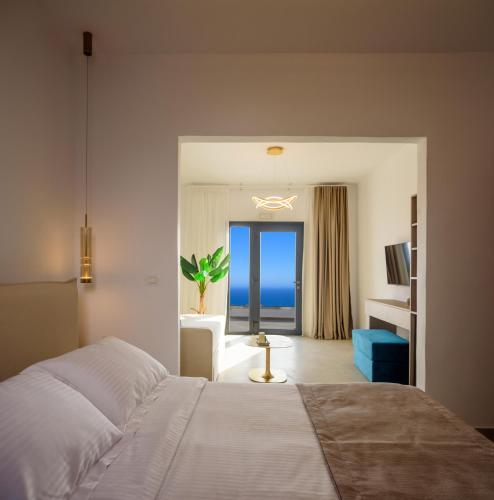 a bedroom with a bed and a view of the ocean at Casa della Liberta in Firostefani