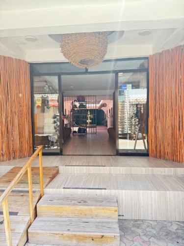 a lobby with stairs and a chandelier at Hotel Casa Caracol in Isla Mujeres