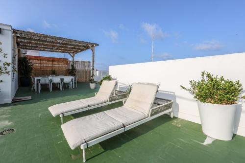 a patio with two chairs and a table on a roof at Apartamento Valencia Malvarrosa in Valencia
