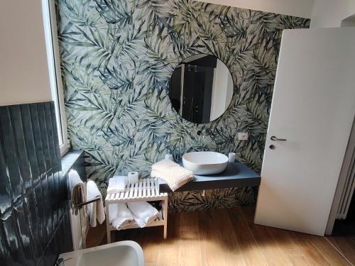 a bathroom with a sink and a mirror at La Terrazza Del Sole di Mondello in Palermo
