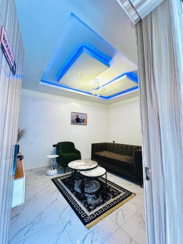 a living room with a couch and a table at Hotel AREX in Iyiba
