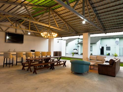 a large living room with a table and chairs at The Emerald Apartments Ibex Meanwood in Lusaka