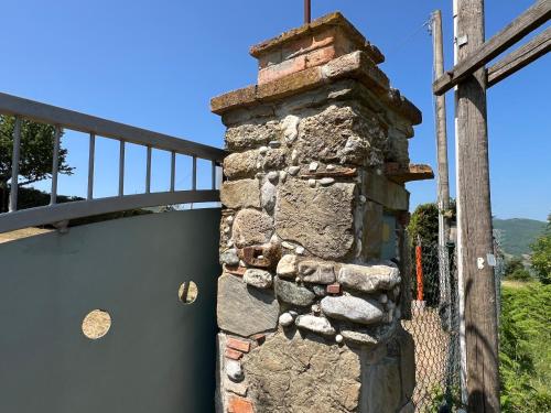 a stone chimney on the side of a building at Casa di campagna nel Parco del Pollino in Teana