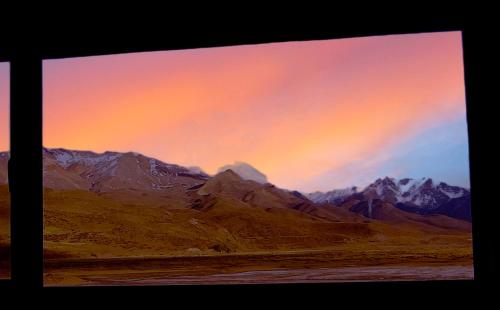 a view of a mountain range with a sunset at La Horqueta in Malargüe