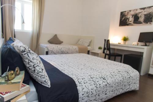 a bedroom with a bed and a desk at Matinee Rooms in Mattinata
