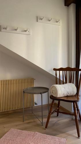 a wooden chair and a stool in a room at Il Cadorino in Valle di Cadore