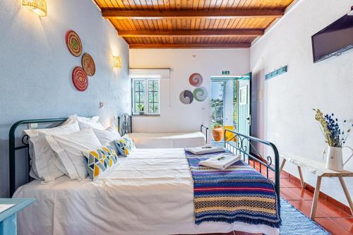 a bedroom with a bed and a table in it at Monte Além Tejo in Arraiolos