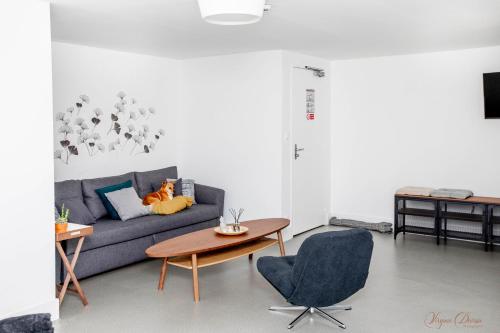 a living room with a couch and a table at L Escale in Ports