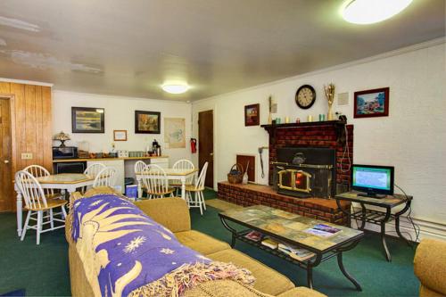 a living room with a couch and a fireplace at Margaretville Motel in Margaretville
