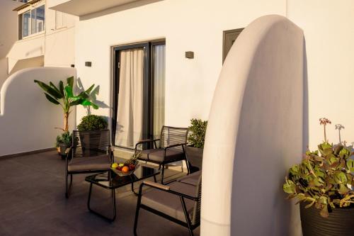 a room with chairs and tables and a surfboard at Casa della Liberta in Firostefani