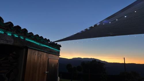 a building with green lights on the side of it at Casa di campagna nel Parco del Pollino in Teana