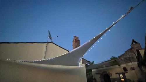 a hammock with lights attached to a building at Casa di campagna nel Parco del Pollino in Teana