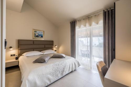 a bedroom with a bed and a large window at Guesthouse Rooms Split in Split